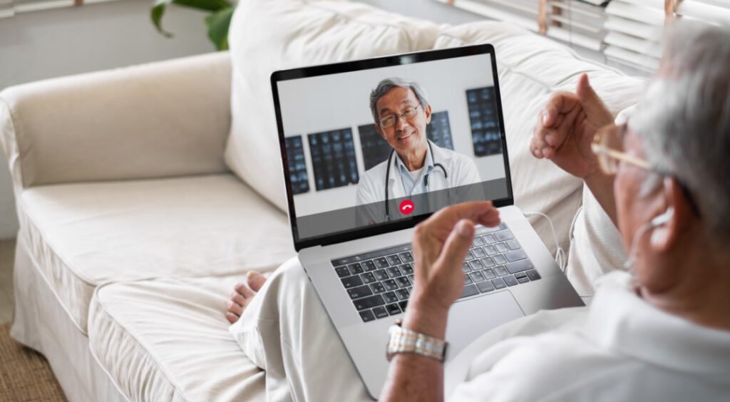 Senior man have a telehealth visit with a doctor on a laptop